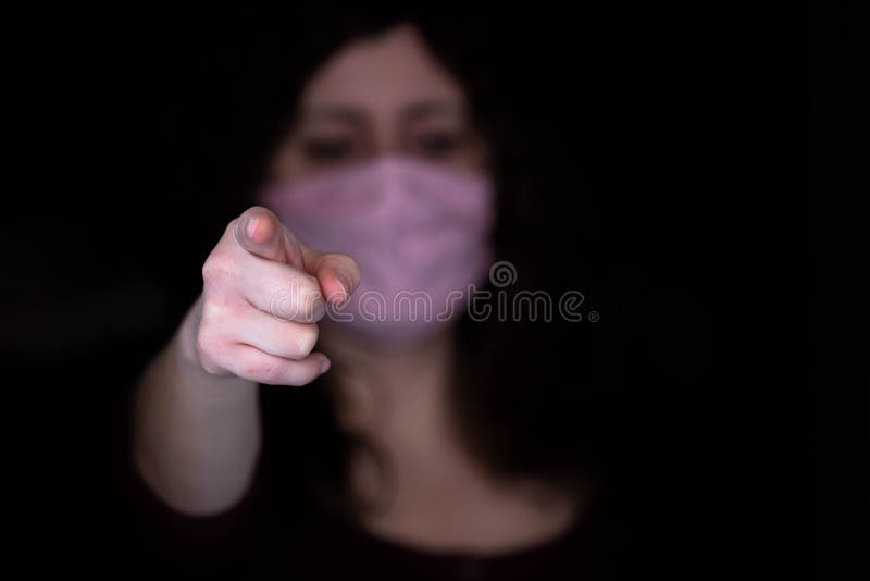 Woman in a mask points to you, protect yourself and others from infection. Covid 19, Coronavirus. Woman in a mask points to you, protect yourself and others from infection. Covid 19, Coronavirus