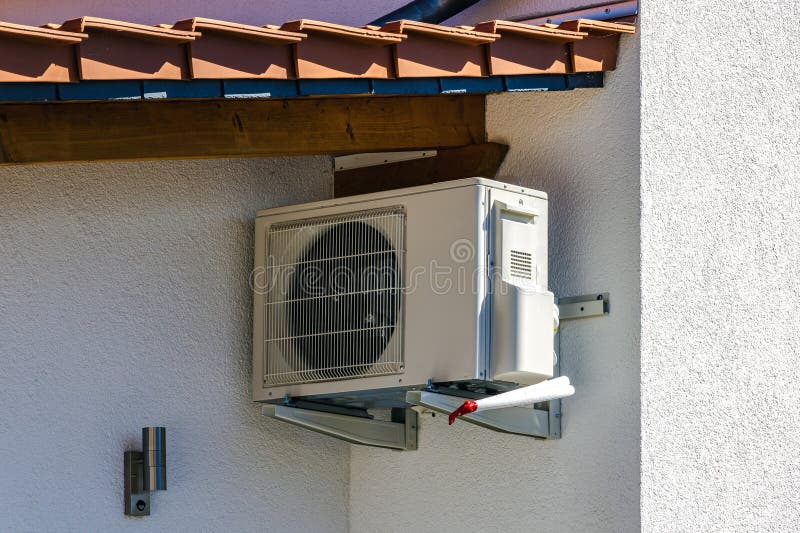 Air conditioning suspended outdoors on the wall of a building or house. Air conditioning suspended outdoors on the wall of a building or house