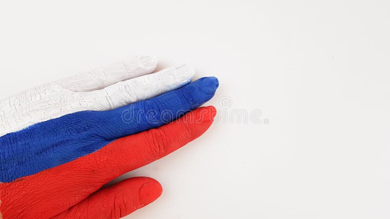 the hand is painted in the color of the Russian flag on a white background. place for text. the hand is painted in the color of the Russian flag on a white background. place for text.
