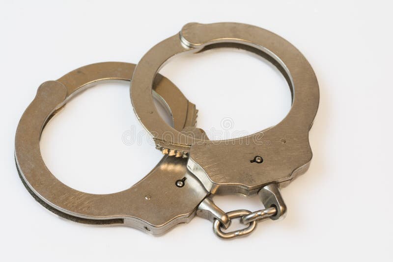 Set of handcuffs on white. Set of handcuffs on white