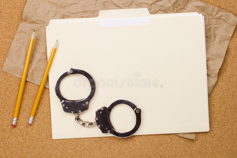 Directly above photograph of handcuffs and a folder. Directly above photograph of handcuffs and a folder.