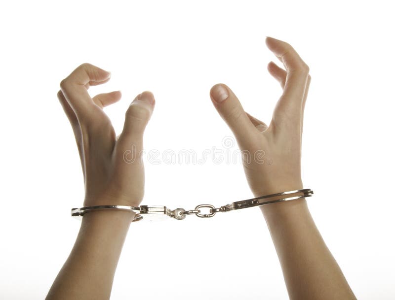 Hands and handcuffs isolated on white background. Hands and handcuffs isolated on white background