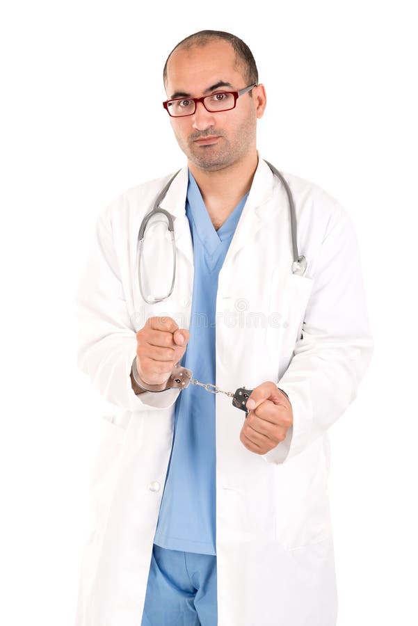 Male doctor in handcuffs isolated in a white background. Male doctor in handcuffs isolated in a white background