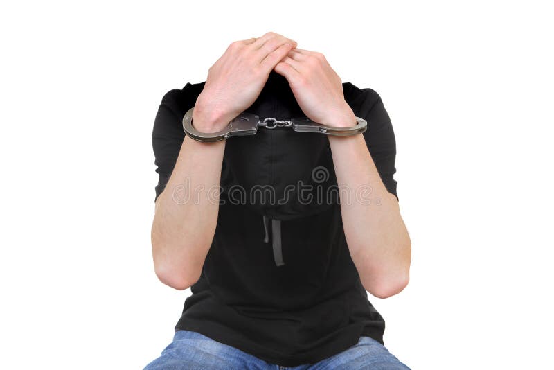 Man in Handcuffs hide his Face and covering his Head Isolated on the White Background. Man in Handcuffs hide his Face and covering his Head Isolated on the White Background