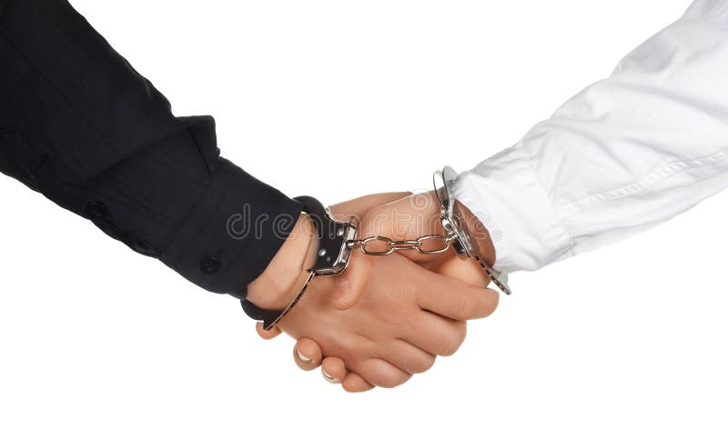 Handshake with handcuffs - reliable agreement concept. Handshake with handcuffs - reliable agreement concept