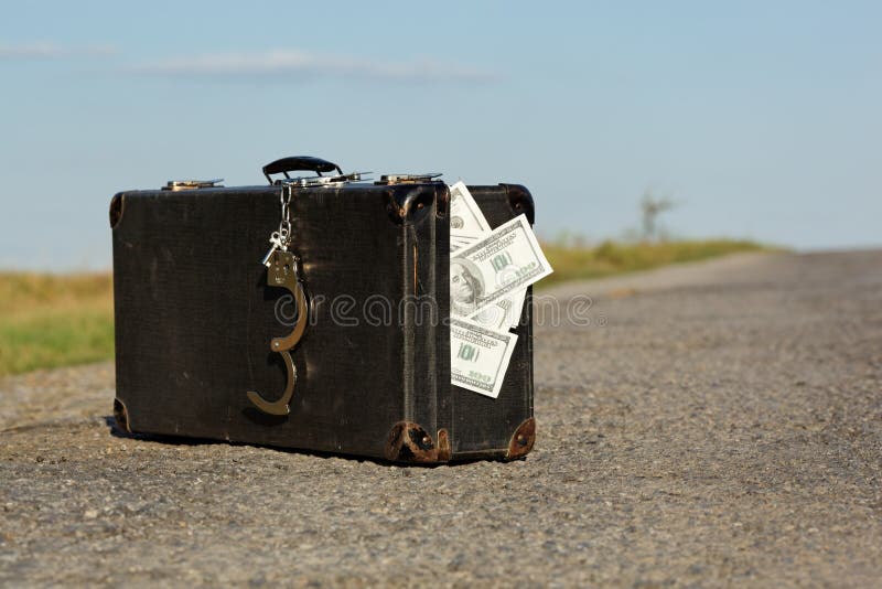 Old suitcase with money and handcuffs for road. Old suitcase with money and handcuffs for road
