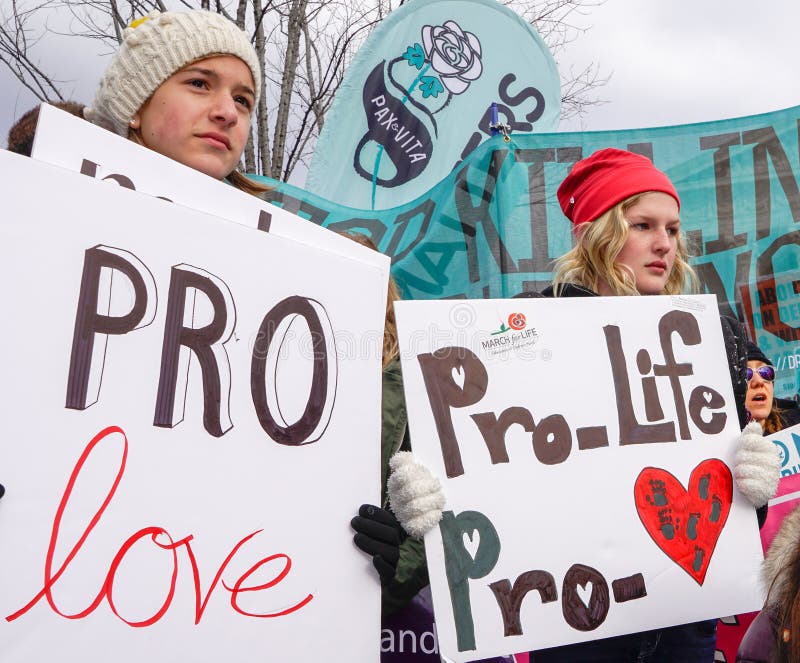 Washington, DC - January 27, 2017: Girls holding signs advocate for life and love during the annual March for Life. Washington, DC - January 27, 2017: Girls holding signs advocate for life and love during the annual March for Life.