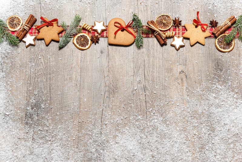 Christmas background with cookies, fir branches and spices on the old grunge wooden board. Christmas background with cookies, fir branches and spices on the old grunge wooden board