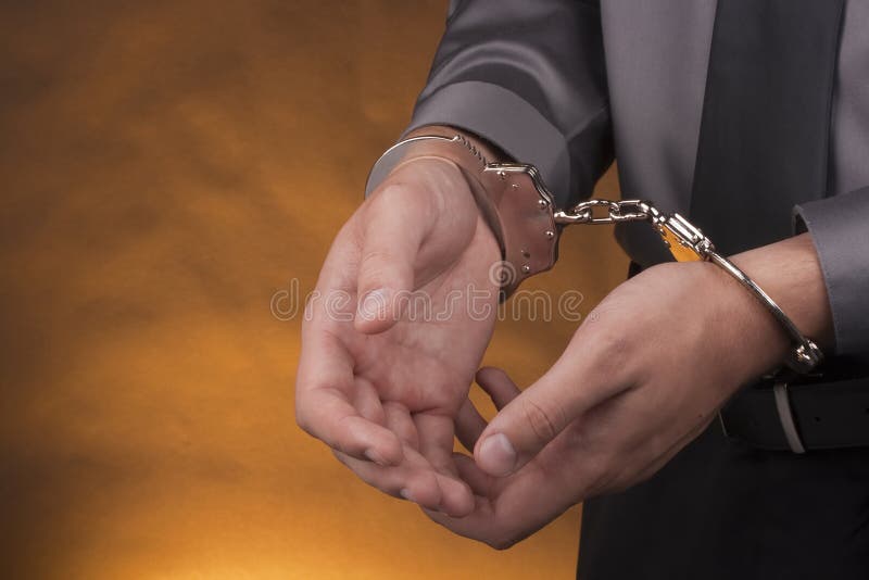 Arrest, close-up shot man's hands with handcuffs. Arrest, close-up shot man's hands with handcuffs.
