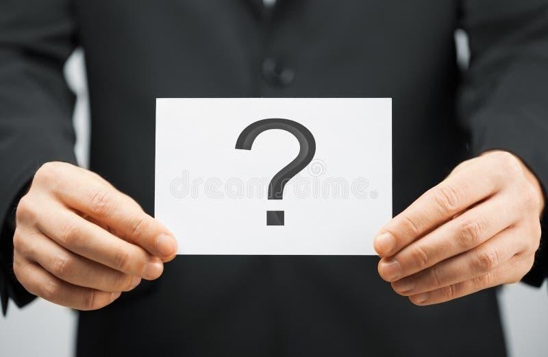 Picture of man in suit holding card with question mark. Picture of man in suit holding card with question mark