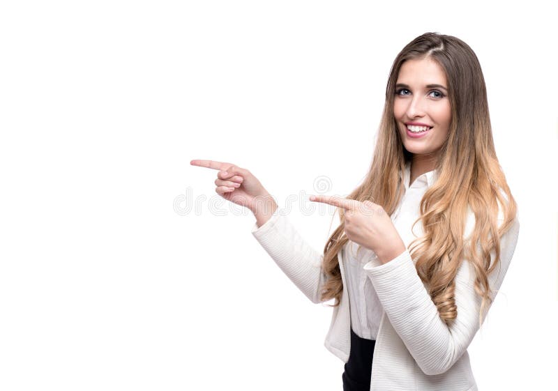 开心美丽的商妇指着在白色背景上隔离的东西 库存图片