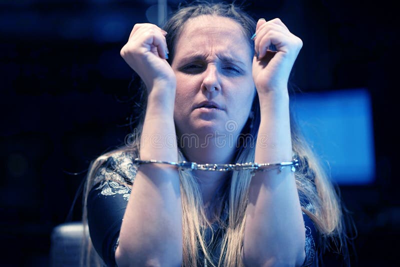 Arrested woman handcuffed hands. Close-up of office worker, Prisoner or arrested terrorist, hacker, bribetaker, close-up of hands in handcuff. Selective focus. Selective focus. Toning. Arrested woman handcuffed hands. Close-up of office worker, Prisoner or arrested terrorist, hacker, bribetaker, close-up of hands in handcuff. Selective focus. Selective focus. Toning