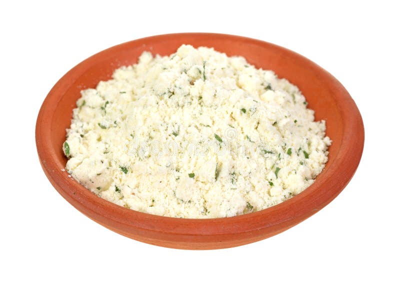 A small clay dish filled with powdered ricotta cheese and herbs on a white background. A small clay dish filled with powdered ricotta cheese and herbs on a white background.