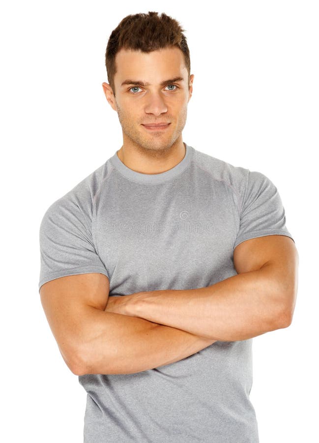 Happy fit male with arms crossed posing over white background. Happy fit male with arms crossed posing over white background