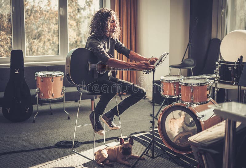 播放前，男性在平板电脑上打开音乐视频. 库存照片