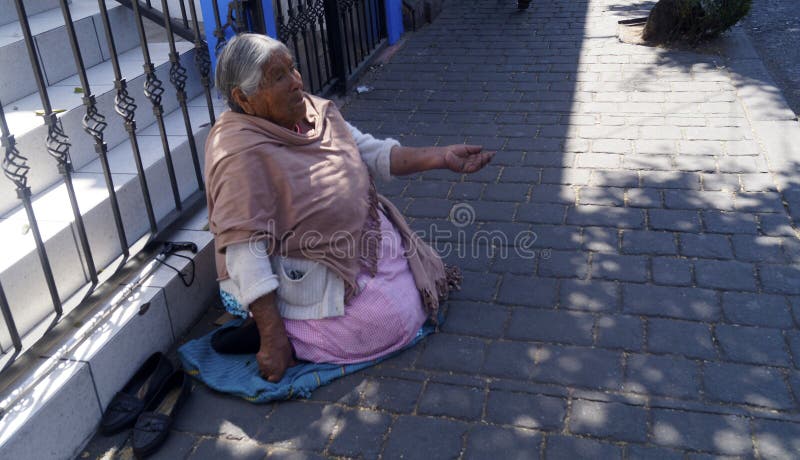 放置在街道的妇女请求金钱 免版税库存图片
