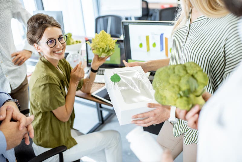 Group of diverse people working on the packaging design of a new eco product in the office. Branding and marketing of new trendy foods concept. Group of diverse people working on the packaging design of a new eco product in the office. Branding and marketing of new trendy foods concept