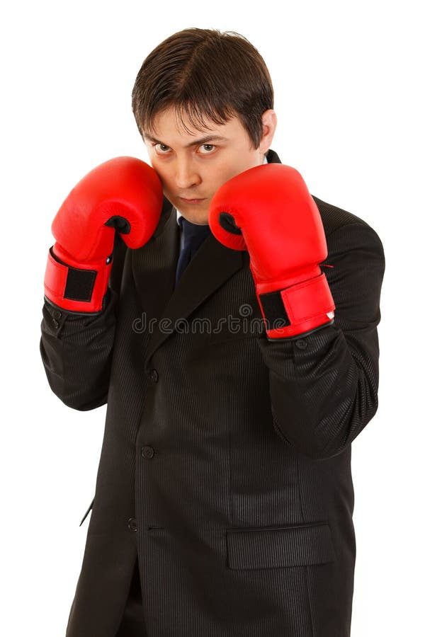 Confident young businessman with boxing gloves isolated on white. Confident young businessman with boxing gloves isolated on white