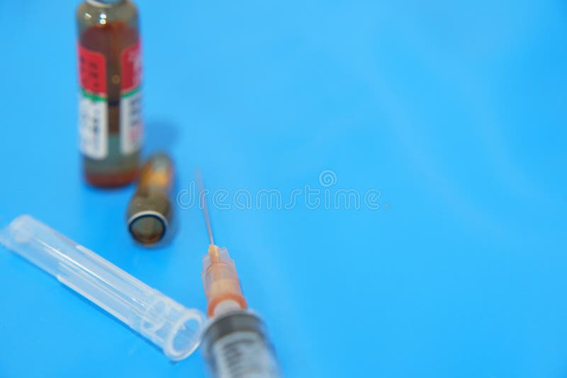 Medical care in uncapped syringe and drug ampule broken in treatment hospital concept. Medical care in uncapped syringe and drug ampule broken in treatment hospital concept