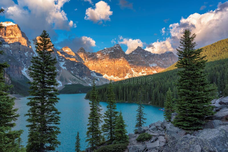 Beautiful turquoise waters of the Moraine lake with snow-covered peaks above it in Banff National Park of Canada. Beautiful turquoise waters of the Moraine lake with snow-covered peaks above it in Banff National Park of Canada