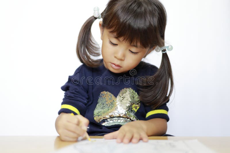 日本女孩画着色素书 免版税库存图片