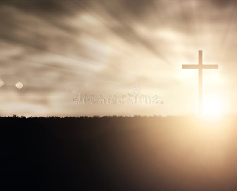 A Christian cross at sunset with light flares. A Christian cross at sunset with light flares.