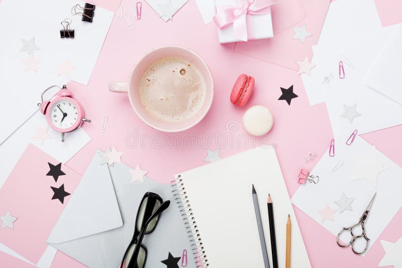 Fashion pink woman workplace background. Coffee, macaron, office supply, gift and clean notebook on pastel desk top view for blogging. Flat lay style. Beautiful morning breakfast. Fashion pink woman workplace background. Coffee, macaron, office supply, gift and clean notebook on pastel desk top view for blogging. Flat lay style. Beautiful morning breakfast.