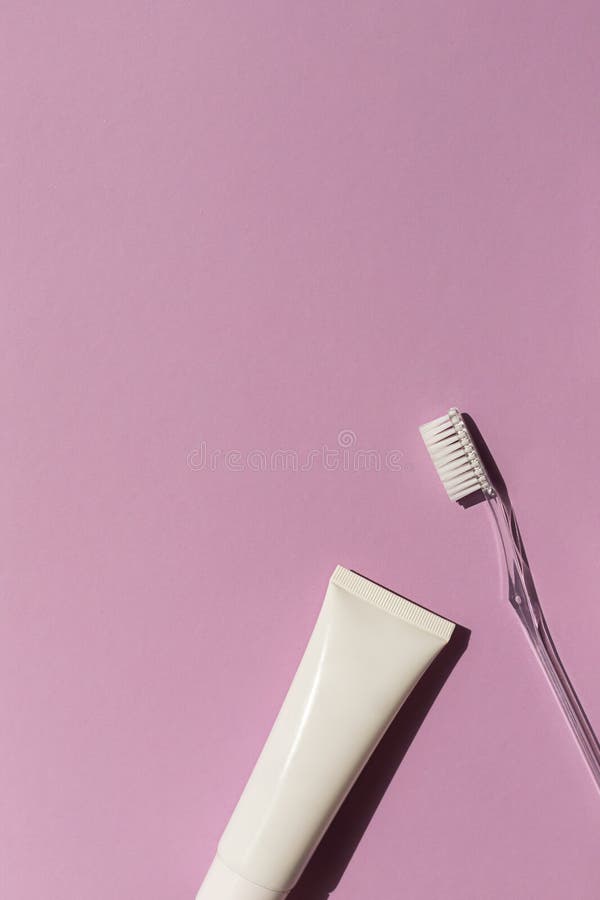 Dental care concept frame with toothbrush and toothpaste on the bright violet background. Copy space. Dental care concept frame with toothbrush and toothpaste on the bright violet background. Copy space