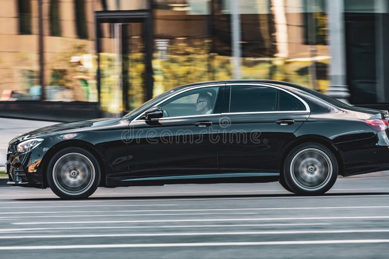 Moscow, Russia - August 2022: Mercedes E Class car in motion on the road on sunny spring day in city. Moscow, Russia - August 2022: Mercedes E Class car in motion on the road on sunny spring day in city