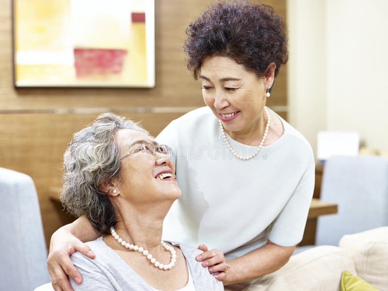 Two senior asian women showing care and friendship. Two senior asian women showing care and friendship