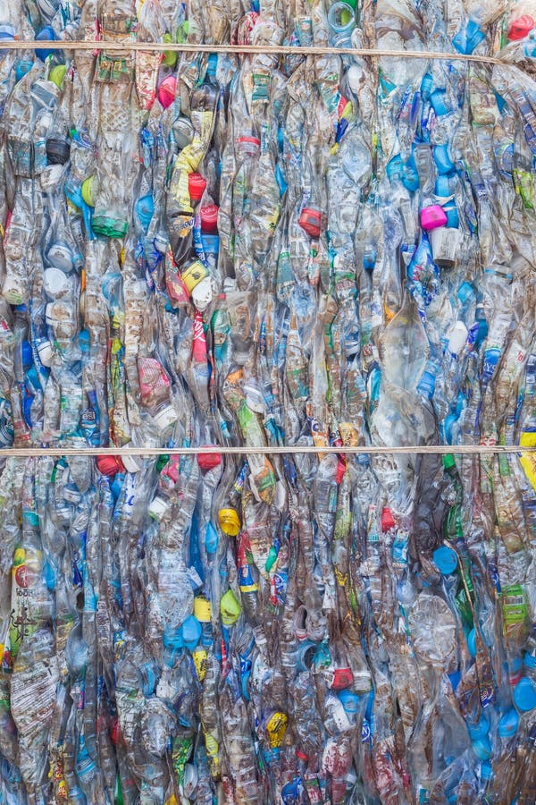 PHUKET, THAILAND - MARCH 3 : Crushed plastic bottles at a recycling facility in Phuket on March 3, 2015. The bottles will be shipped to a plastic foundry. PHUKET, THAILAND - MARCH 3 : Crushed plastic bottles at a recycling facility in Phuket on March 3, 2015. The bottles will be shipped to a plastic foundry.