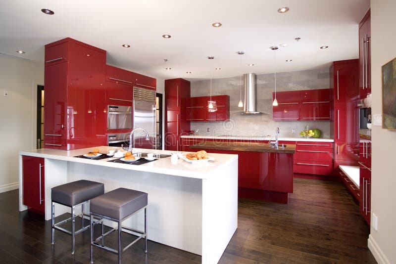 Contemporary red modern kitchen with 2 different island and a dark wooden floor. Contemporary red modern kitchen with 2 different island and a dark wooden floor