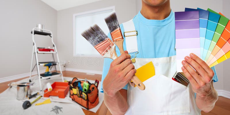 Professional man painter hand with brush. House renovation. Professional man painter hand with brush. House renovation