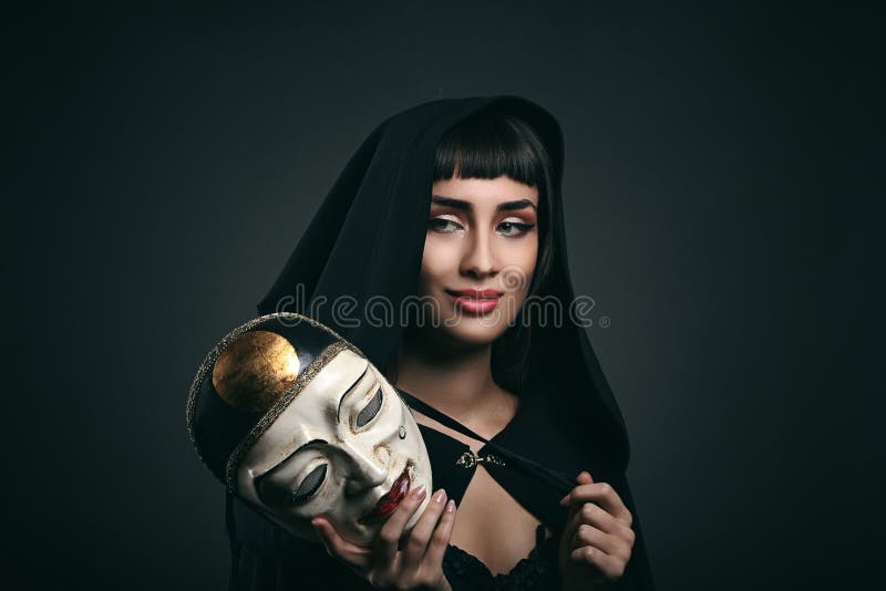 Beautiful woman with black robe and mask. Venetian carnival. Beautiful woman with black robe and mask. Venetian carnival