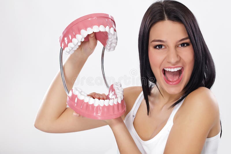 Funny woman holding open jaws, showing healthy teeth. Funny woman holding open jaws, showing healthy teeth