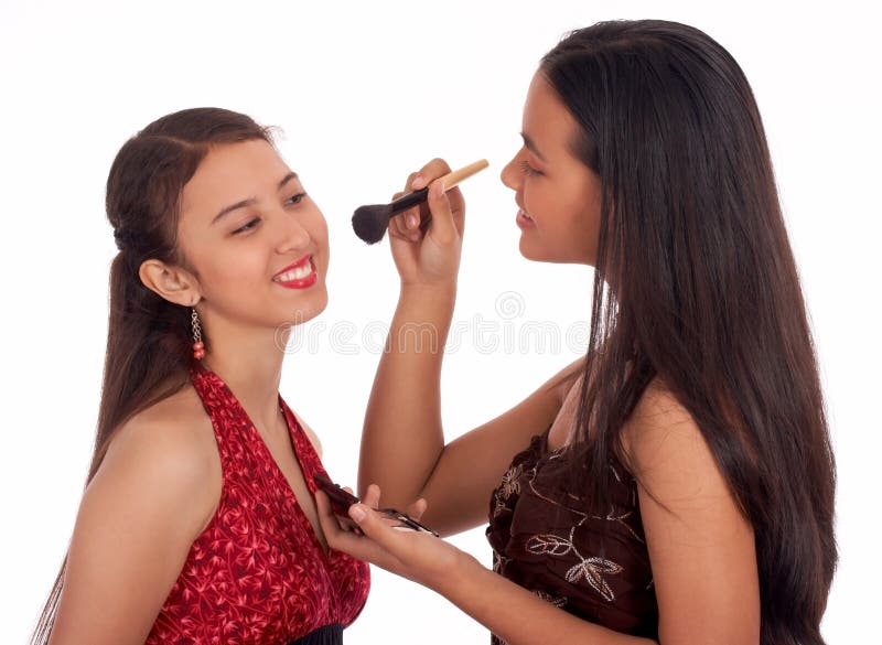 Two young girls having fun putting make up. Two young girls having fun putting make up