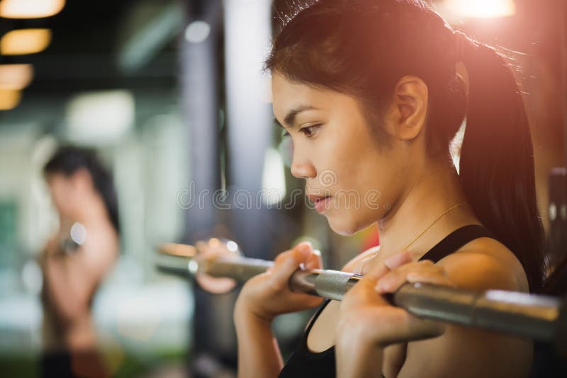 有做的锻炼坚强的年轻亚裔妇女与杠铃 库存照片 有做的锻炼坚强的年轻亚裔妇女与杠铃 库存照片