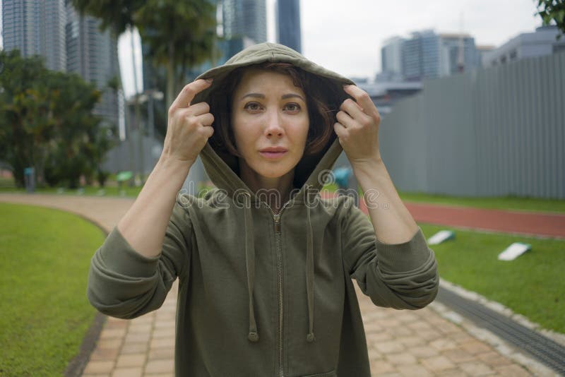 有冠乌鸦上面的年轻可爱和活跃慢跑者妇女准备好早晨连续锻炼在健身体育的美丽的城市公园 库存照片 有冠乌鸦上面的年轻可爱和活跃慢跑者妇女准备好早晨连续锻炼在健身体育的美丽的城市公园 库存照片