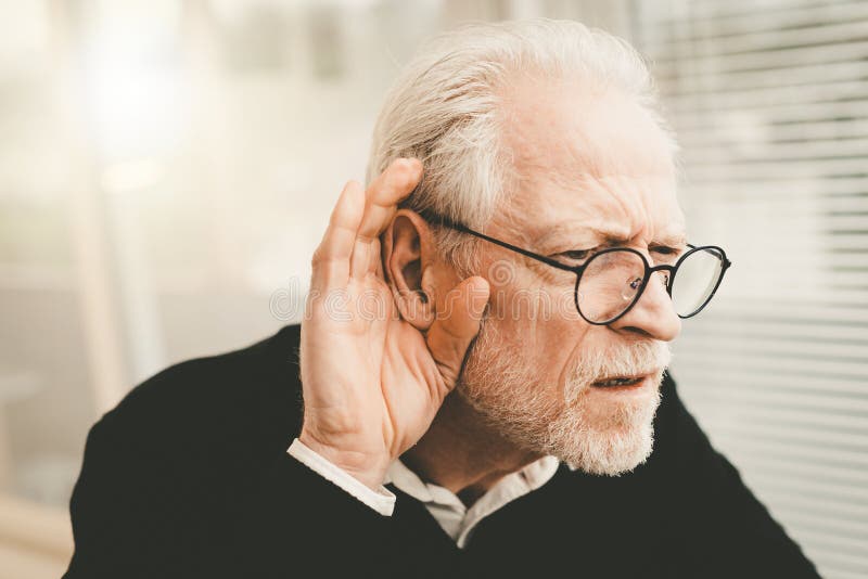 Portrait of senior man having hearing problems. Portrait of senior man having hearing problems
