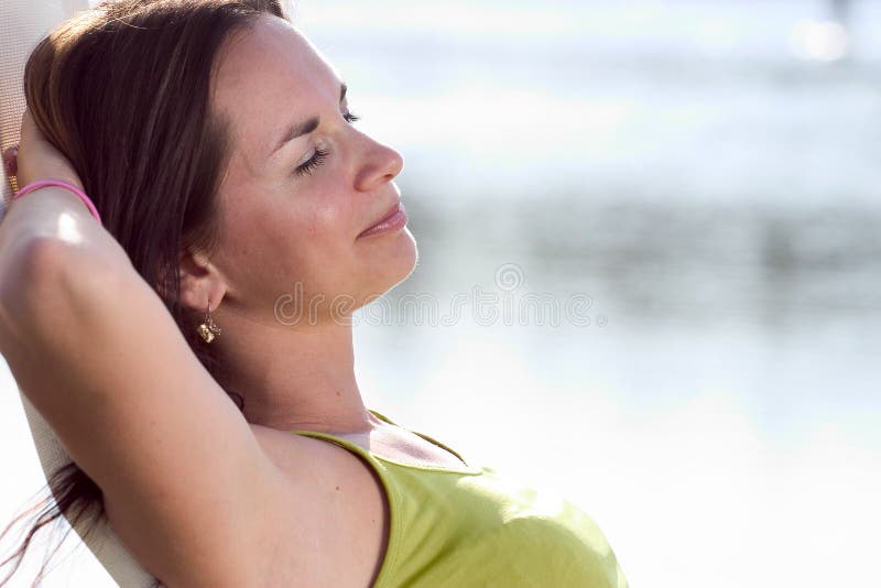 Attractive model relaxing on a deckchair. Attractive model relaxing on a deckchair.