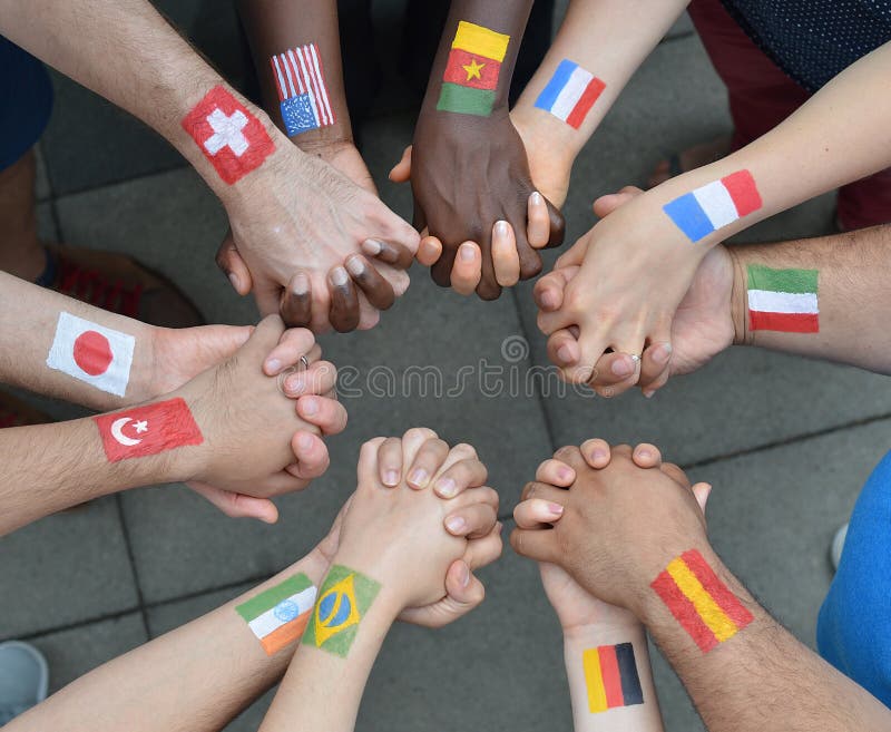 International brothers and sisters standing in a circle together and holding hands. International brothers and sisters standing in a circle together and holding hands