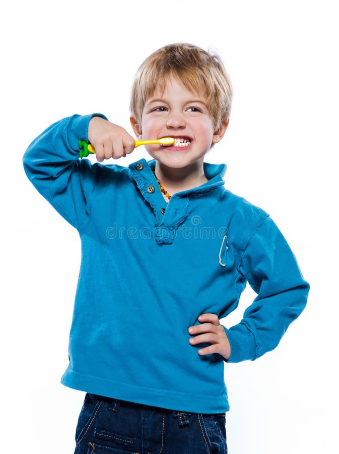 Studio portrait of a beautiful cute caucasian blond boy with a toothbrush. Studio portrait of a beautiful cute caucasian blond boy with a toothbrush