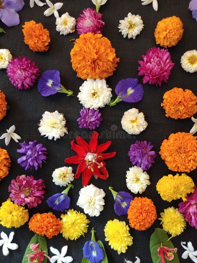 A close up of an interesting flower design consisting of bunch of flowers including marigold, aster and a unique wild flower in the center. A close up of an interesting flower design consisting of bunch of flowers including marigold, aster and a unique wild flower in the center.