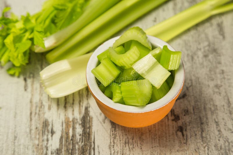 Fresh celery sticks on a wooden background. Food concept. Fresh celery sticks on a wooden background. Food concept.