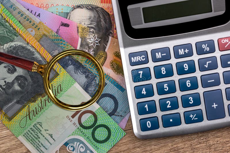 Australian dollar banknotes with calculator on wooden table. Australian dollar banknotes with calculator on wooden table.