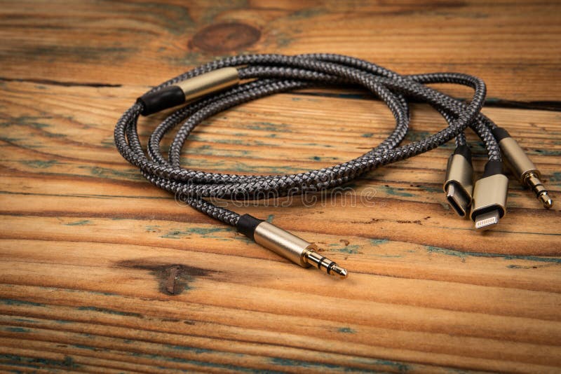 3 In 1 Type-C 3.5mm Jack Aux Cable on wooden background. 3 In 1 Type-C 3.5mm Jack Aux Cable on wooden background.