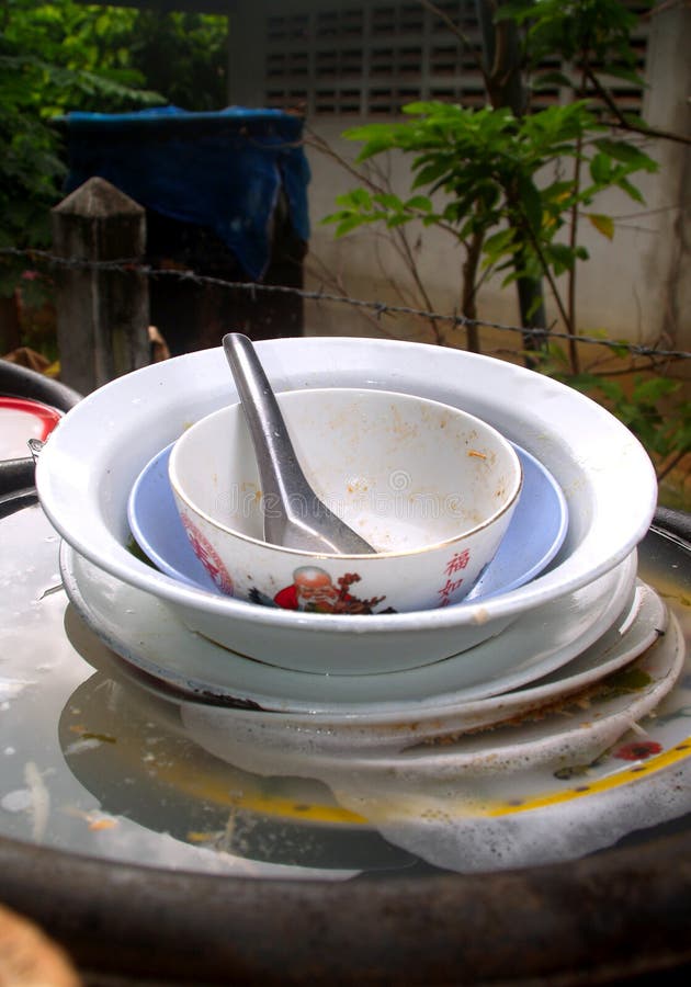 A photo of Unwashed dishes in the sink. A photo of Unwashed dishes in the sink