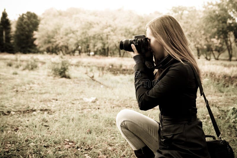 Woman the photographer on the nature. Woman the photographer on the nature