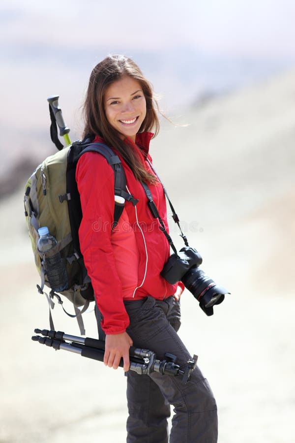 Photographer outdoors in nature taking pictures during hiking trip on Teide, Tenerife, Canary Islands. Beautiful smiling Asian /Caucasian woman. Photographer outdoors in nature taking pictures during hiking trip on Teide, Tenerife, Canary Islands. Beautiful smiling Asian /Caucasian woman.