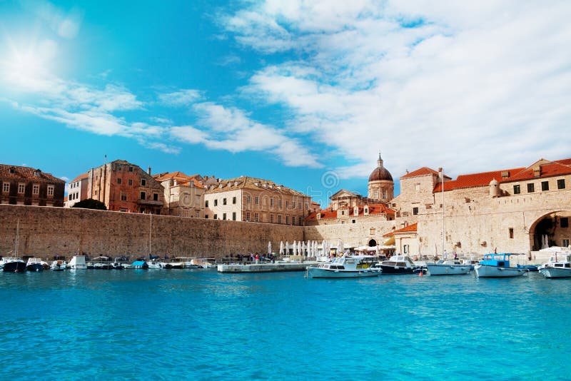 Port of Dubrovnik from water in sunny day with boats parked to the peer. Port of Dubrovnik from water in sunny day with boats parked to the peer